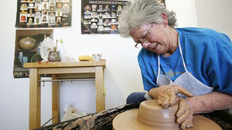 Independent artist Lynn Wheeler throws a pot in the space she rents at the Rosewood Arts Center on Wednesday. TY GREENLEES / STAFF