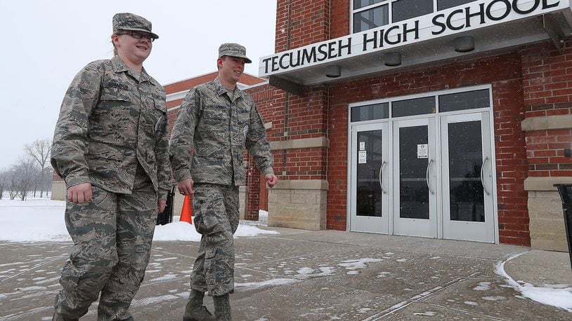 Tecumseh ROTC Cadet TSgt Harley Adamson and Cadet Major Matthew Lindamood walk past one of the entrances to Tecumseh High School this month. Tecumseh ROTC will try to reschedule a run planned to benefit Honor Flight and to honor veterans of the Bataan Death March. BILL LACKEY/STAFF