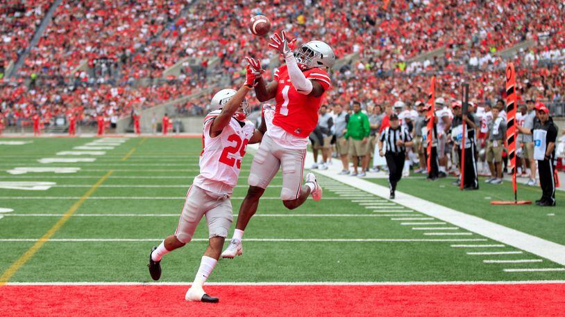 Ohio State’s Johnnie Dixon catches a touchdown pass against Rodjay Burns in the spring game on Saturday, April 15, 2017, at Ohio Stadium in Columbus. David Jablonski/Staff