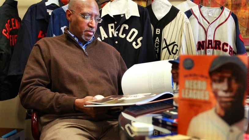 Michael Carter, a senior advisor to the president at Sinclair Community College and the school’s Chief Diversity Officer, with jerseys, memorabilia, and books from the Negro Leagues. Carter is one of the key people putting on Wednesday’s Joe Morgan HBCU Classic matching Wilberforce University’s baseball team against Kentucky State, both Historic Black Universities. FILE PHOTO