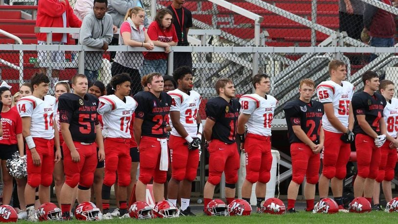 Milton-Union and Northridge high school football players stand together for the playing of the national anthem in honor of the U.S. response to 9/11. Milton-Union defeated visiting Northridge 69-35 in the Week 4 SWBL game on Friday, Sept. 15, 2017. CONTRIBUTED PHOTO