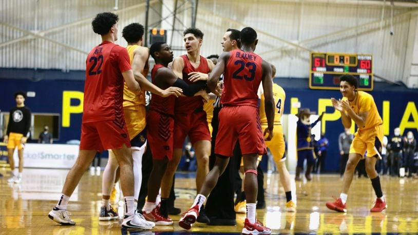 Dayton and La Salle players have words after a missed 3-pointer in the final second by Koby Brea, center, on Saturday, Feb. 26, 2022, at Tom Gola Arena in Philadelphia, Pa. David Jablonski/Staff