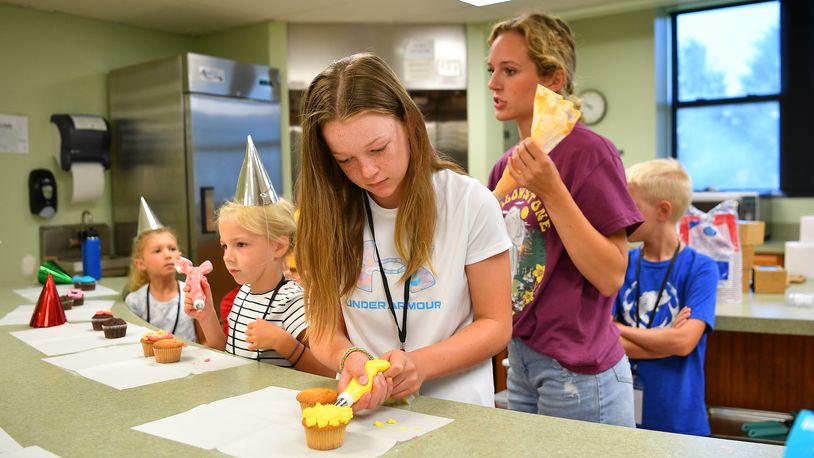 Participants in this summer's Jr. Chef program offered by the Miami County Ohio State University Extension Office try their hand at decorating cupcakes. Contributed
