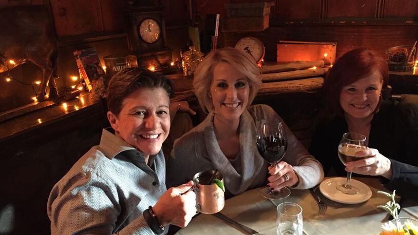 Author and former Scientologist Michelle LeClair (center) enjoys a meal with her partner, Tena Clark (left) and Michelle's mother (right). LeClair accuses the Church of Scientology of ruining her career when she left the group.