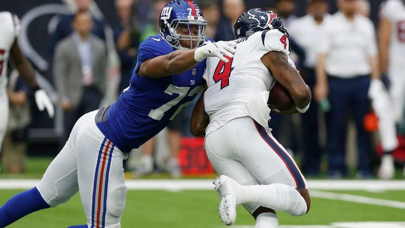 HOUSTON, TX - SEPTEMBER 23: Deshaun Watson #4 of the Houston Texans is pressured by Kerry Wynn #72 of the New York Giants in the second quarter at NRG Stadium on September 23, 2018 in Houston, Texas. (Photo by Tim Warner/Getty Images)