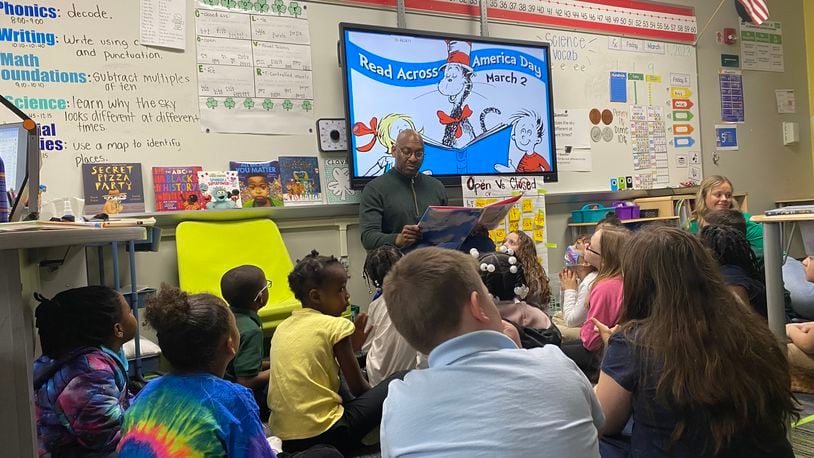David Lawrence, Dayton Public Schools superintendent, reads to first-graders at Cleveland Elementary on Friday, March 1. The school was celebrating Read Across America Day on Saturday, March 2. Eileen McClory/ Staff