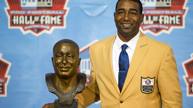 CANTON, OH - AUGUST 3: Former receiver Cris Carter of the Minnesota Vikings poses with his bust during the NFL Class of 2013 Enshrinement Ceremony at Fawcett Stadium on Aug. 3, 2013 in Canton, Ohio. (Photo by Jason Miller/Getty Images)