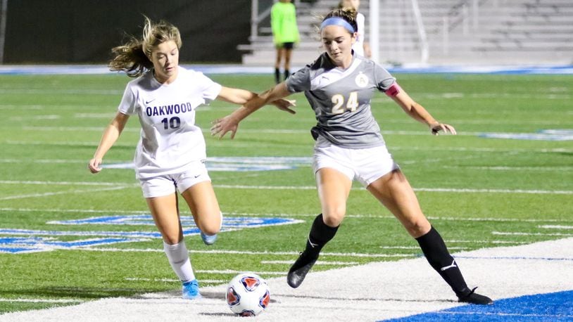 Alter High School’s Lauren Schimpf and Oakwood’s Riley Beam tussle for the ball during their match on Tuesday night at Miamisburg’s Holland Field. The Knights won 3-0. CONTRIBUTED PHOTO BY MICHAEL COOPER