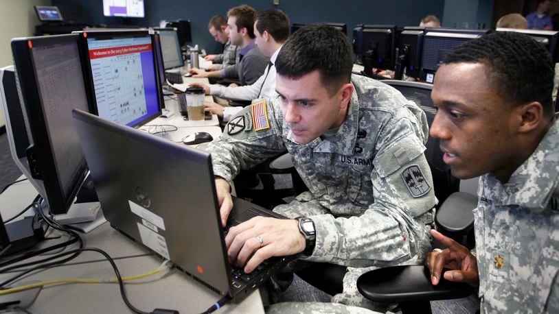 U.S. Army Majors Paul Williams, left, and Brian Beam competed in the Air Force Institute of Technology Cyber Defense and Exploitation Capstone Exercise as part of their graduate studies in February 2019. TY GREENLEES / STAFF