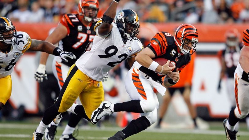 CINCINNATI - SEPTEMBER 27: Carson Palmer #9 of the Cincinnati Bengals runs with the ball while defended by James Harrison #92 of the Pittsburgh Steelers at Paul Brown Stadium on September 27, 2009 in Cincinnati, Ohio. The Bengals won 23-20. (Photo by Andy Lyons/Getty Images)