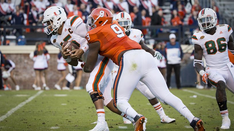 CHARLOTTESVILLE, VA - NOVEMBER 12: Brad Kaaya #15 of the Miami Hurricanes is sacked by Andrew Brown #9 of the Virginia Cavaliers during a game at Scott Stadium on November 12, 2016 in Charlottesville, Virginia. (Photo by Chet Strange/Getty Images)