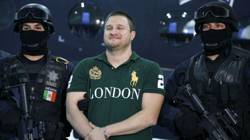 In this Aug. 31, 2010 file photo, Texas-born fugitive Edgar Valdez Villarreal, also known as "La Barbie," center, reacts during his presentation to the media after his arrest in Mexico City.