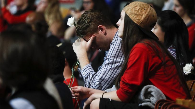Students Tanner Hale, center, and Kayla Croyle attend a vigil following an attack at The Ohio State University campus the previous day, Tuesday, Nov. 29, 2016, in Columbus, Ohio. Investigators are looking into whether a car-and-knife attack at Ohio State University that injured several people was an act of terror by a student who had once criticized the media for its portrayal of Muslims. (AP Photo/John Minchillo)
