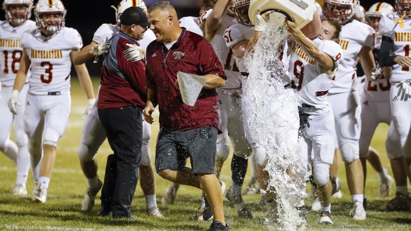 Northeastern High School football coach Jake Buchholtz gets doused with water after the Jets beat Fairbanks 42-7 on Friday, Oct. 21, 2022 at Kyre Field in Milford Center. CONTRIBUTED PHOTO BY MICHAEL COOPER