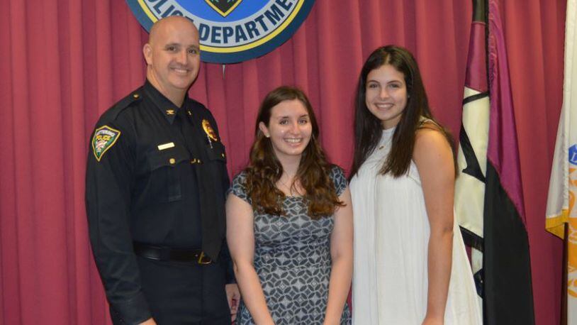 Kettering Police Chief Chip Protsman and scholarship award winners Amanda Fanz of Fairmont high and Faith Stuart of Alter high. (Courtesy/Kettering Police Department).