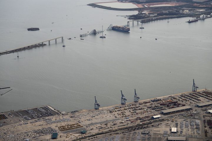 
                        An aerial view of the Dali container ship with a collapsed section of the Francis Scott Key Bridge across its bow after it collided with the bridge early Tuesday morning and the Dundalk Marine Terminal in the foreground in Baltimore, Md., on Tuesday, March 26, 2024. Six construction workers who had been fixing potholes on the Francis Scott Key Bridge remained missing as divers and other emergency workers on boats and helicopters continued to search for them. Two others had been rescued. (Erin Schaff/The New York Times)
                      