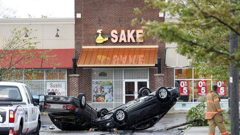 A tornado on May 26 toppled cars and damaged businesses at the Greene Crossing Shopping Center in Beavercreek. LISA POWELL / STAFF