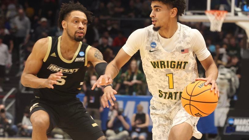 Wright State’s Trey Calvin works around Bryant’s Charles Pride Wednesday, March 16, 2022 during a NCAA First Four game at UD Arena. BILL LACKEY/STAFF