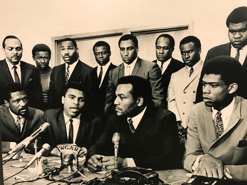 Photo of the famed Cleveland Summit convened by Browns great Jim Brown in 1967, gathered athletes and others…(Front Row: left to right in front): Bill Russell, Muhammad Ali, Jim Brown and Lew Alcindor who became Kareem Abdul-Jabbar. (Back row, left to right)  Rep. Carl Stokes, Walter Beach (Cleveland Browns), Bobby Mitchel (Washington Redskins), Sid Williams (Browns), Curtis McClinton (Kansas City Chiefs), Willie Davis (Green Bay Packers), Jim Shorter (Browns), John Wooten (Browns)