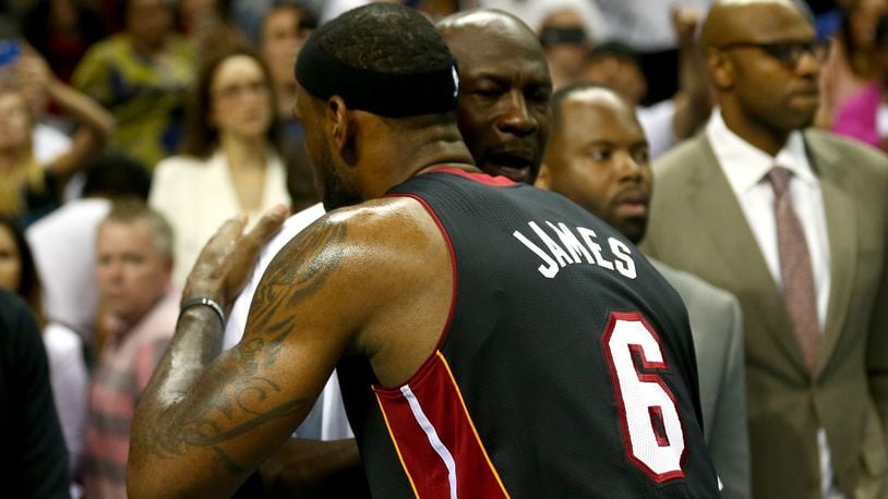 CHARLOTTE, NC - APRIL 28:  LeBron James #6 of the Miami Heat hugs Michael Jordan after defeating the Charlotte Bobcats 109-98 in Game Four of the Eastern Conference Quarterfinals during the 2014 NBA Playoffs at Time Warner Cable Arena on April 28, 2014 in Charlotte, North Carolina. NOTE TO USER: User expressly acknowledges and agrees that, by downloading and or using this photograph, User is consenting to the terms and conditions of the Getty Images License Agreement.  (Photo by Streeter Lecka/Getty Images)