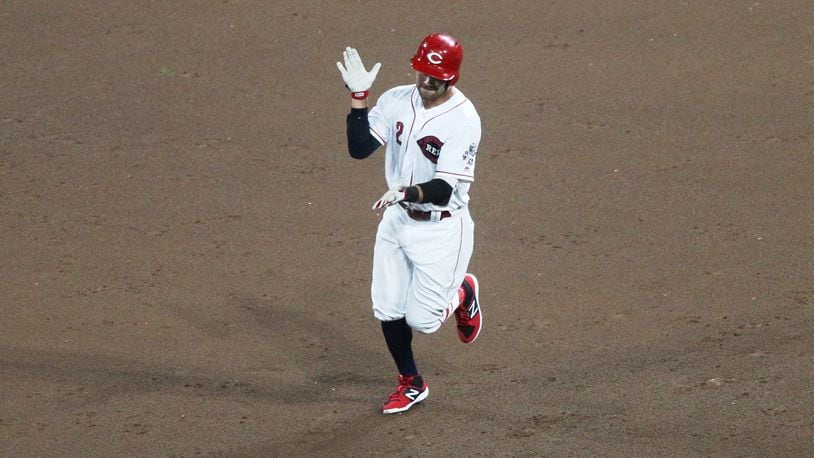 The Reds’ Alex Blandino claps as he runs to second base after a two-run double in the eighth inning against the Chicago White Sox on Monday, July 2, 2018, at Great American Ball Park in Cincinnati. David Jablonski/Staff