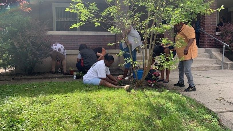Residents and volunteers plant together at Mercy Manor. CONTRIBUTED