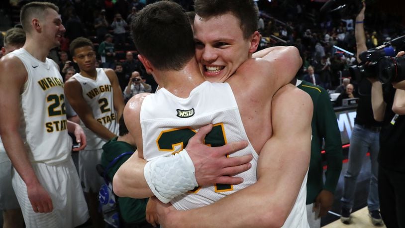 Wright State’s guard Grant Benzinger, right, celebrates with Cole Gentry after the team’s 74-57 win over Cleveland State during an NCAA college basketball game for the championship in the Horizon League men’s tournament in Detroit, Tuesday, March 6, 2018. (AP Photo/Paul Sancya)