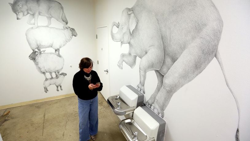 Large-scale drawings by artist Andrew Dailey, "Counting Sheep" and " Bloated Elevation" are on display in the Fountain Gallery, a secluded area at the back the The Contemporary Dayton. The art work will be on display until Dec. 21. LISA POWELL / STAFF