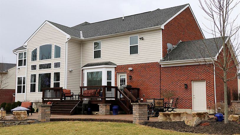 A rear deck and paver-brick patio are accessible from the breakfast room. Finished space above the garage is a recreation room with a wet bar. The basement has been finished into a game room, family room, kitchenette and half bathroom.