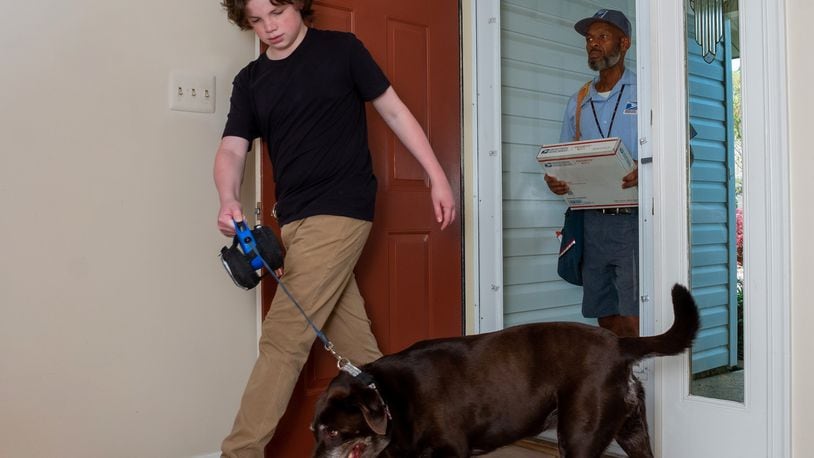 Images of letter carrier delivering to a house with dogs for the dog bite awareness campaign. 