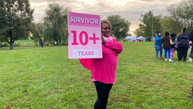 Mercedes Johnson, a breast cancer survivor, holds up a sign during the Making Strides of Greater Dayton event on Saturday. Eileen McClory / Staff