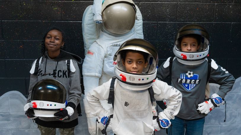 Kiser Elementary students pose next to a mannequin in the Challenger Learning Center’s Moon Room. The Moon Room is designed to teach students about the moon, and even allows them to dress up as astronauts as they explore. CONTRIBUTED