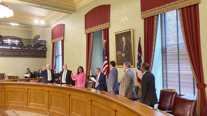 Members of the Ohio Redistricting Commission – from left, Senate President Matt Huffman, Auditor Keith Faber, House Minority Leader Emilia Sykes, Gov. Mike DeWine, Secretary of State Frank LaRose, House Speaker Bob Cupp and Sen. Vernon Sykes – take their oath at the Ohio Statehouse in Columbus, Ohio, during their first meeting on Aug. 6, 2021. (AP Photo/Julie Carr Smyth)