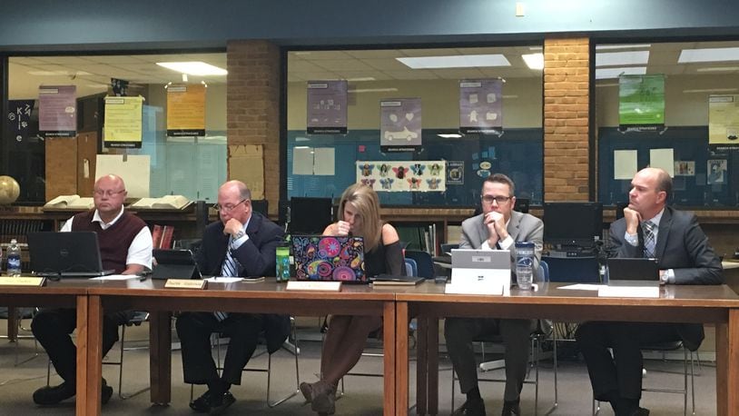 The letter read by Dave Stuckey, at left, the president of the Springboro school board, accused member Lisa Babb, at center, of colluding with a former employee.