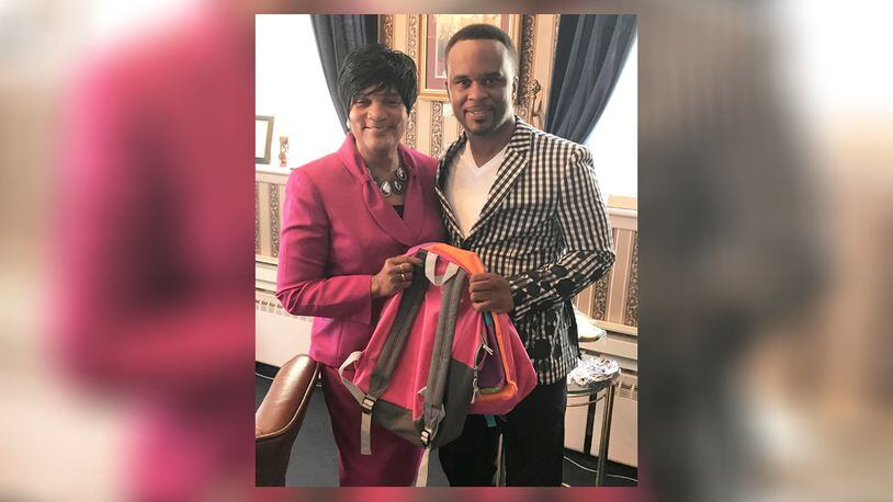 Elder Belinda Mitchell and her nephew, Pastor Paul Mitchell, hold a new bookbag that’s one of many to be handed out to Westwood children at the Revival Center Ministries’ second annual Community Outreach Day. CONTRIBUTED