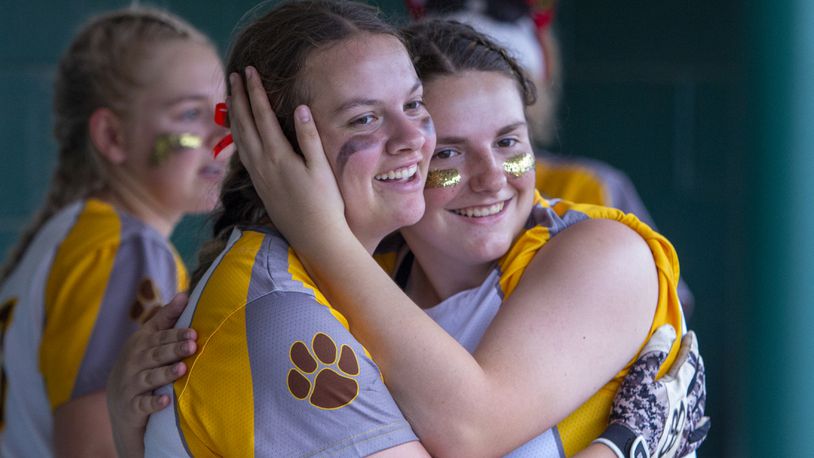 Kenton Ridge sophomore Natalee Fyffe (left) gets a hug from teammate Kyanne Tyson after hitting a two-run homer in the second inning Saturday to tie the score at 2-2. Jonathan Alder went on to win the Division II region final 5-2 at Mason. Photo by Jeff Gilbert