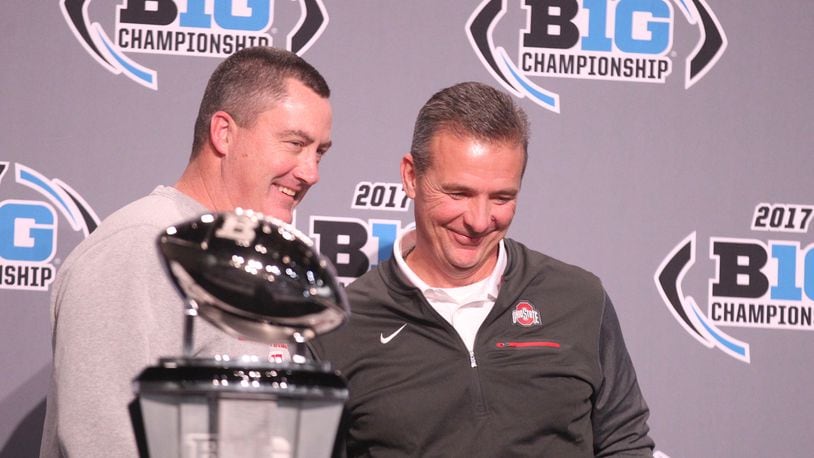Wisconsin coach Paul Chryst and Ohio State coach Urban Meyer pose for a photo with the Big Ten Championship trophy on Friday, Dec. 1, 2017, at Lucas Oil Stadium in Indianapolis. David Jablonski/Staff