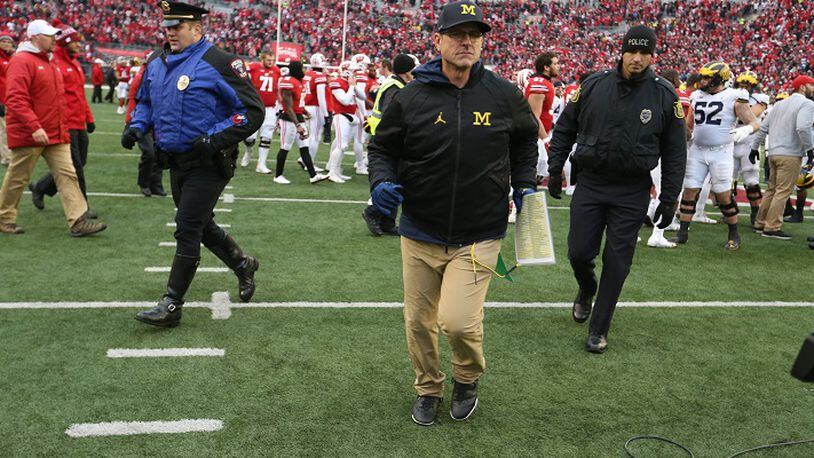 Michigan head coach Jim Harbaugh leaves the field after the 24-10 loss to Wisconsin Saturday, Nov. 18, 2017 at Camp Randall Stadium in Madison, Wis. (Kirthmon F. Dozier/Detroit Free Press/TNS)