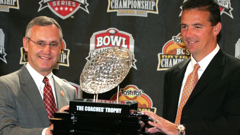 7 Jan 07 Photo by Ron Alvey. Jim Tressel (left), the Ohio State football coach, pose for a picture with Florida Gator coach Urban Meyer. The two are in front of one of the college fooball championship trophies. The two teams play Monday night in the BCS Championship Game.