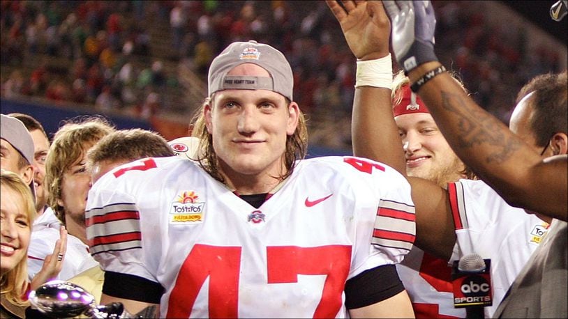 TEMPE, AZ - JANUARY 02:  Linebacker A.J. Hawks #47 of the Ohio State Buckeyes holds his defensive player of the game award as his teammates cheer after the Buckeyes defeated the Notre Dame Fighting Irish in the Tostito's Fiesta Bowl at Sun Devil Stadium on January 2, 2006 in Tempe, Arizona. The Buckeyes defeated the Fighting Irish 34-20.  (Photo by Jeff Gross/Getty Images)