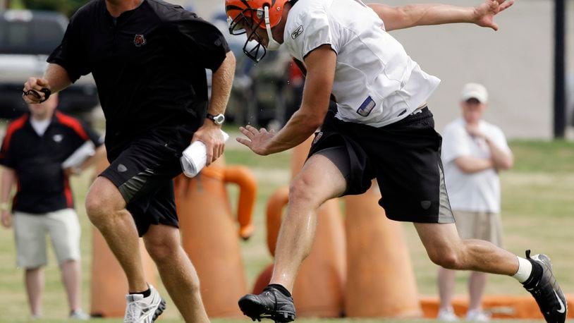 Cincinnati Bengals kicker Dave Rayner runs downfield with special teams coach Darrin Simmons, left, after Rayner kicked off during practice Thursday, Aug. 5, 2010, at the NFL football team's training camp in Georgetown, Ky. (AP Photo/Al Behrman)