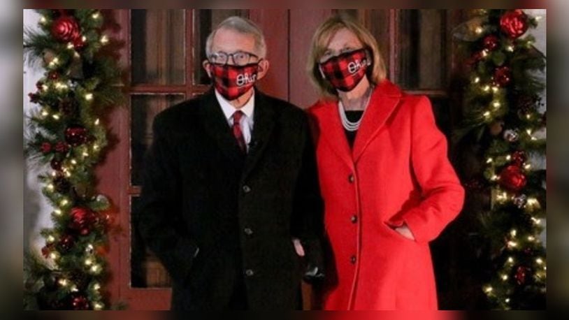 Ohio Gov. Mike DeWine and first lady Fran DeWine don masks as they stand outside their home decorated for the holidays. CONTRIBUTED