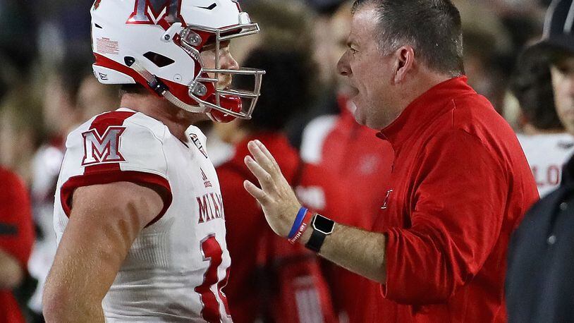 Head coach Chuck Martin of the Miami Redhawks talks to quarterback Gus Ragland on the sidelines during a game against the Notre Dame Fighting Irish at Notre Dame Stadium on September 30, 2017 in South Bend, Indiana. (Photo by Jonathan Daniel/Getty Images)