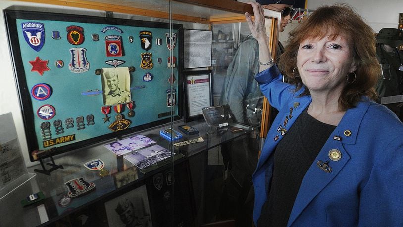 Catherine Beers-Conrad's is the spokeswoman for the Miami Valley Military History Museum at 4 E. Main St., in Fairborn. Beers-Conrad's stands by her father's display at the museum. Her father died during the Vietnam War. MARSHALL GORBY\STAFF