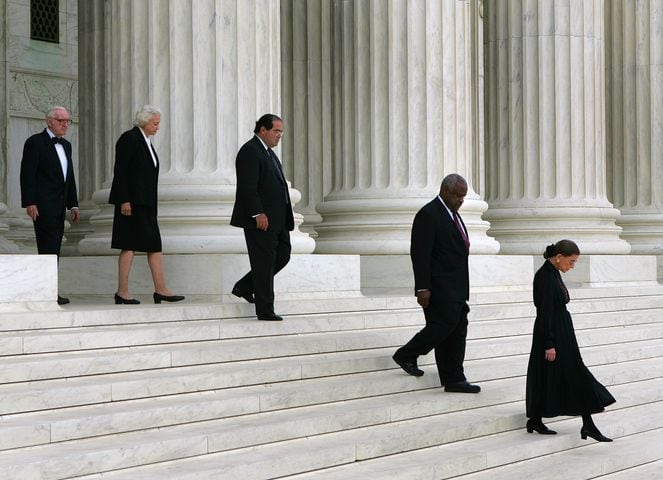 FILE -- From right, Justice Ruth Bader Ginsburg and her fellow justices Clarence Thomas, Antonin Scalia, Sandra Day O'Connor and John Paul Stevens leave the Supreme Court building for the casket procession of the late Chief Justice William Rehnquist, in Washington, Sept. 6, 2005. Ginsburg, the second woman to serve on the Supreme Court and a pioneering advocate for women’s rights, who in her ninth decade became a much younger generation’s unlikely cultural icon, died of complications from metastatic pancreas cancer on Friday, Sept. 18, 2020. She was 87. (Doug Mills/The New York Times)