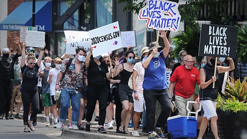 Protesters march through the Oregon District in Dayton Thursday afternoon, June 4, 2020. MARSHALL GORBY / STAFF