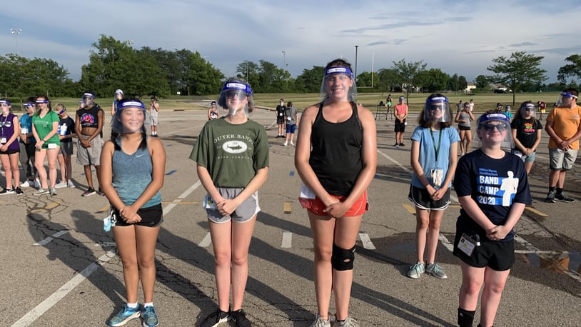 Area school officials say summer band and sports practices have been good testing sessions for students learning safe practices they will soon need as classes begin opening for the new school year. Pictured are Mason High School band members wearing face shields during practice. (Provided Photo\Journal-News)