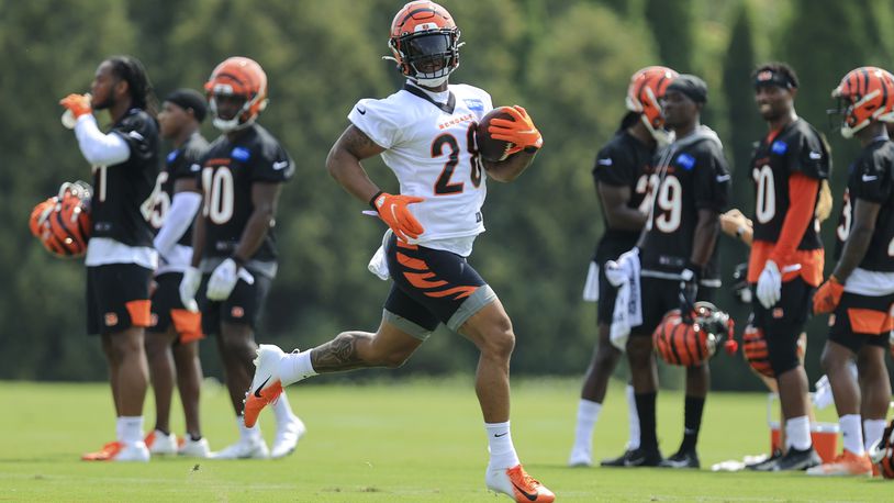 Cincinnati Bengals' Joe Mixon carries the ball during NFL football practice in Cincinnati, Wednesday, July 28, 2021. (AP Photo/Aaron Doster)