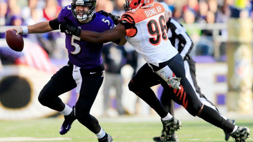 BALTIMORE, MD - NOVEMBER 10: Defensive end Carlos Dunlap #96 of the Cincinnati Bengals sacks quarterback Joe Flacco #5 of the Baltimore Ravens during the second quarter at M&T Bank Stadium on November 10, 2013 in Baltimore, Maryland. (Photo by Rob Carr/Getty Images)
