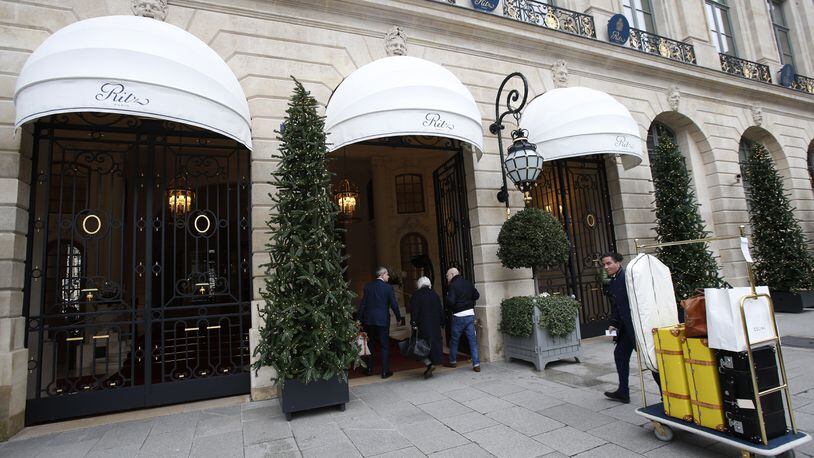 FILE - In this Jan.11, 2018 file photo, people enter the Ritz hotel in Paris, Thursday, Jan. 11, 2018. The Ritz hotel is putting to auction more than 10,000 pieces of furniture and decorative objects including bathtubs, beds and minibars emblematic of the luxury afforded by the wealthy clients of the glitzy palace. (AP Photo/Michel Euler, File)